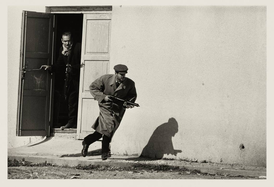 A Turkish Cypriot bursts out of the side-door of a cinema clutching a gun, in the middle of the Cyprus Civil War.
